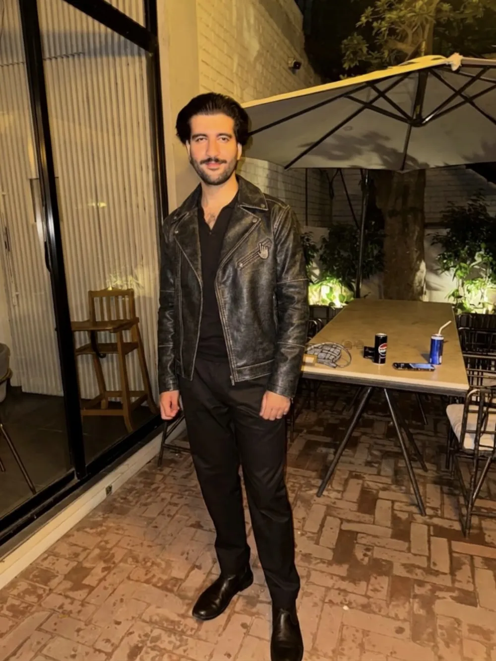 The same man wearing the black leather biker jacket (AI-generated preview).